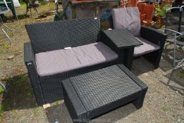 A plastic wicker Garden sofa, chair and coffee table a/f. 5" x 33 12/2" x 28" high.