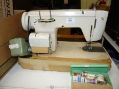 A Jones electric sewing machine with attachments.