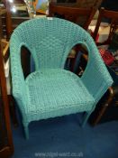 A turquoise Lloyd Loom style chair.