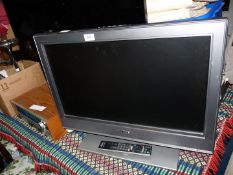 A 'Sony Bravia' 26" screen TV with remote.