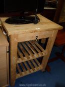 A Pine kitchen island with two lower shelves, 23 1/2'' x 19 3/4'' x 33 1/2'' high.
