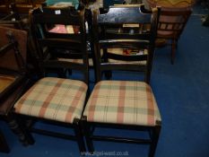 A set of four I. & J.L. Brown ladder back dining chairs with gingham seats.