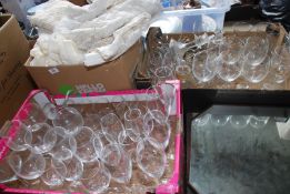 Two boxes of glasses, candlesticks, champagne and wine glasses etc plus a box of net curtains.