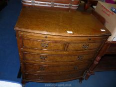 A Mahogany bow fronted Chest of two short over three long drawers with brushing slide.