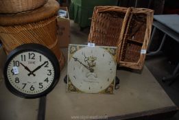 An old style plastic Grandfather clock face by Watkins of Abergavenny and a picnic basket.