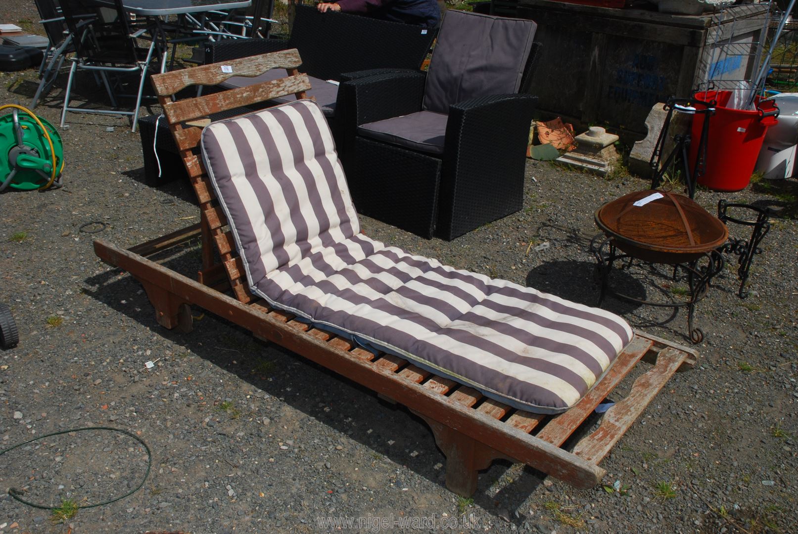 A wooden reclining Sun Lounger/Steamer with cushion.