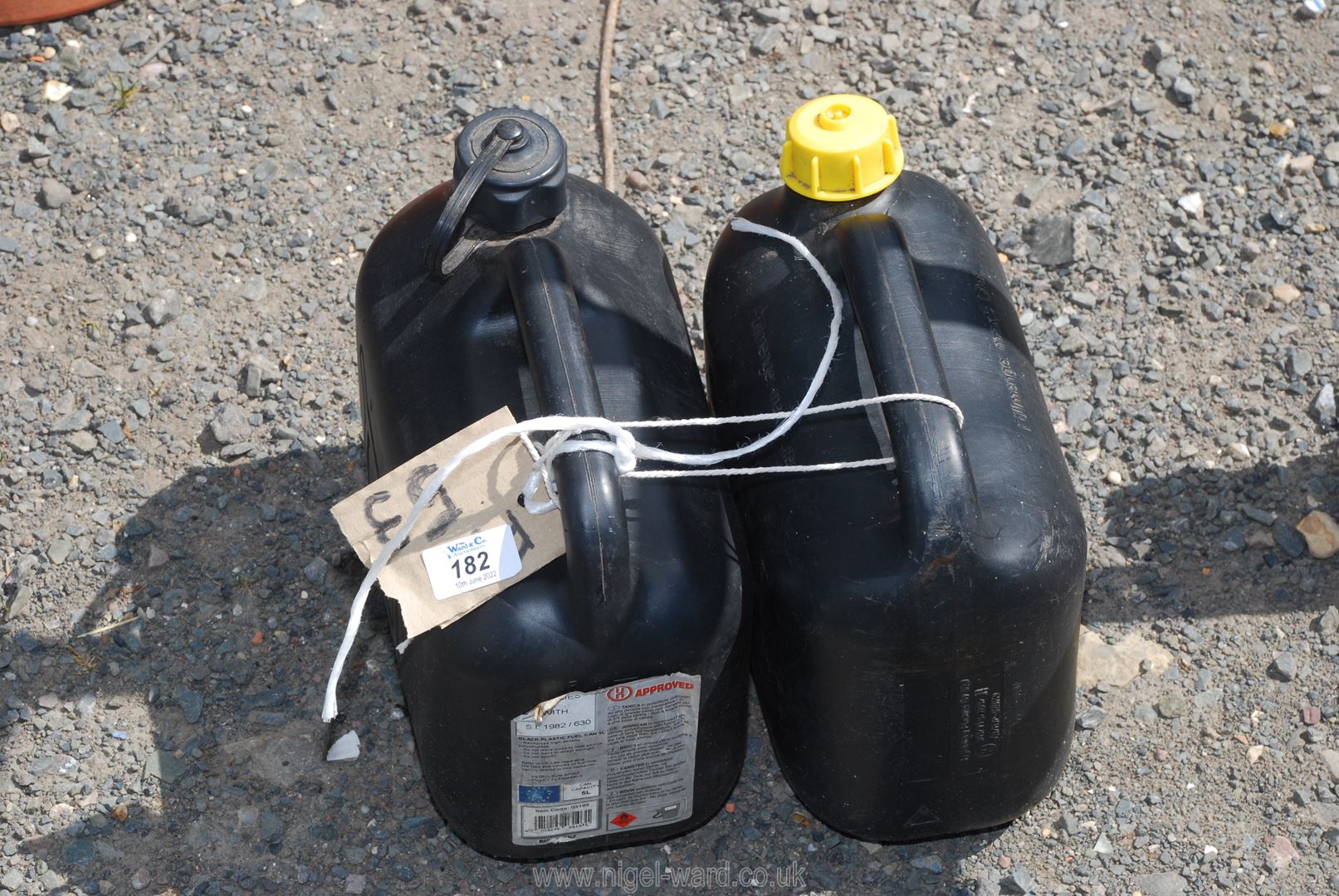 2 Black plastic diesel/petrol cans.