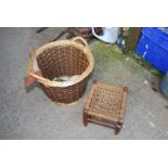 A log basket with hatchet and small rope topped stool.