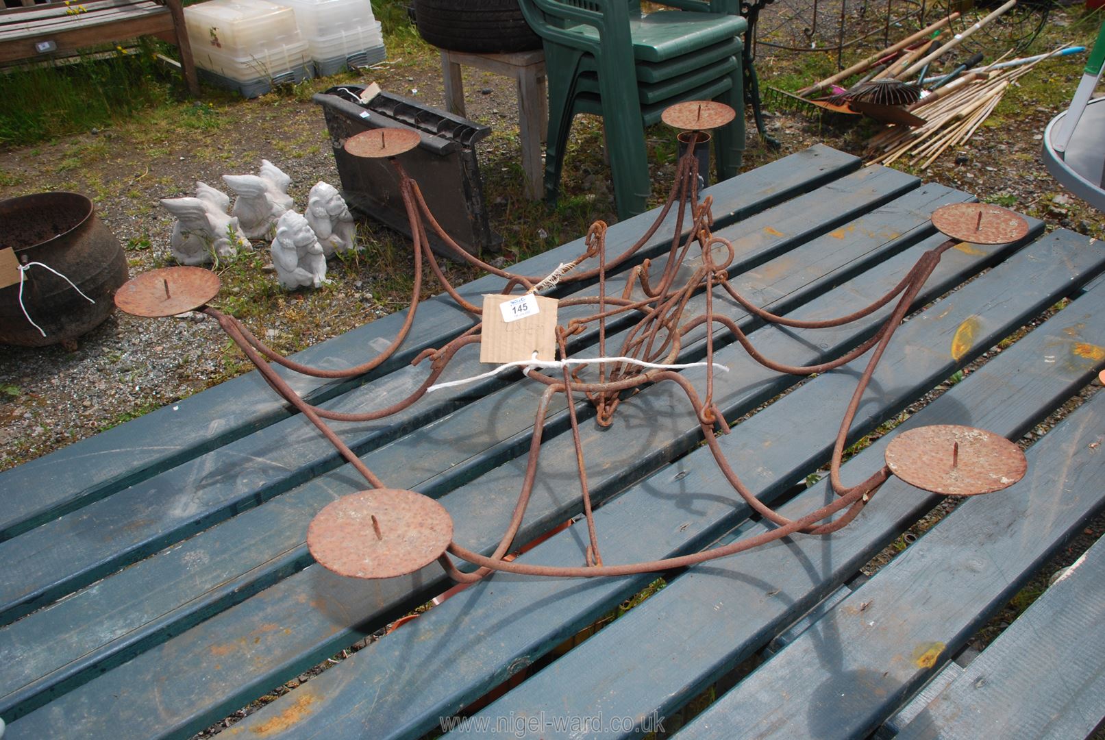 A hanging metal candle chandelier with six branches.