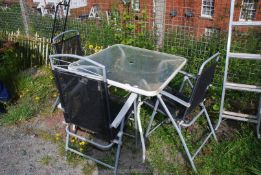 A glass topped garden table, 34'' square x 28'' high and three chairs.