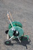 A wheeled hose on reels.