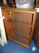 A glass fronted bookcase, 28" x 9" x 38 1/4" high.