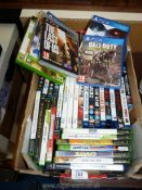 A box of Xbox and Playstation games.