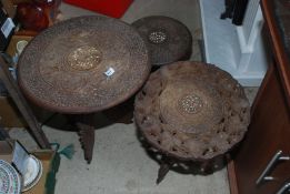 Three carved teak oriental style folding plant stands.