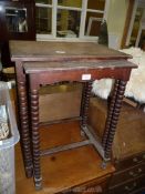 A nest of two Oak tables with bobbin turned legs.