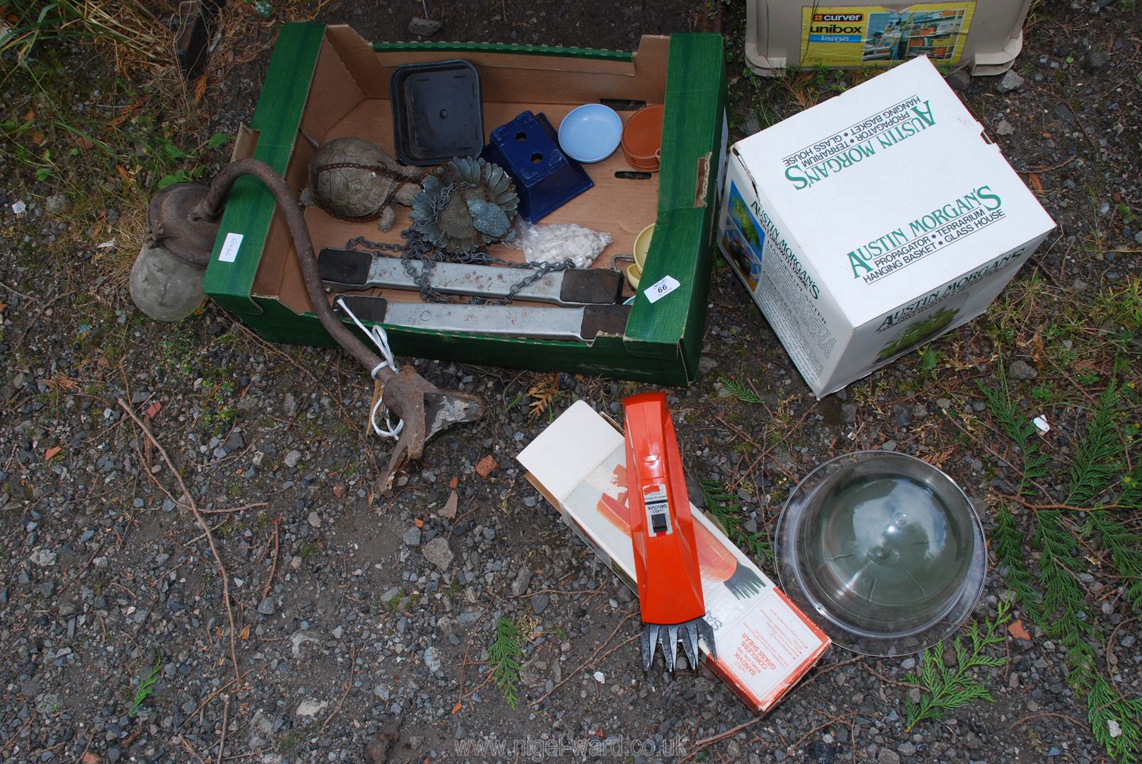 A garden ornament, pot mover, Sandvik glass shears, plant dome, outside light, etc.