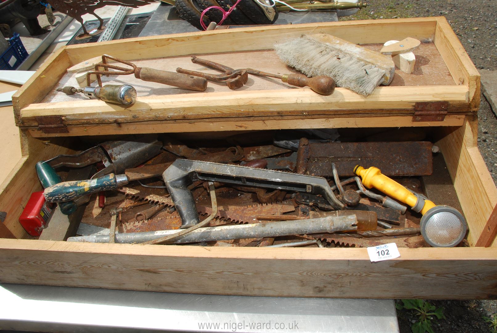 A wooden tool box with contents.