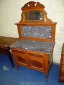An Oak marble topped Washstand with marble upstand and swing mirror, 36" x 18" x 52" high overall.