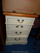 A bedside chest of four drawers.