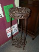A wrought iron pot stand.