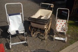 A doll's pram, a pushchair by Surrey Princess Toy Company and one other.