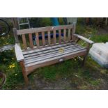 A wooden garden bench, 50" wide x 32" high x 19" deep.