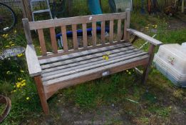 A wooden garden bench, 50" wide x 32" high x 19" deep.