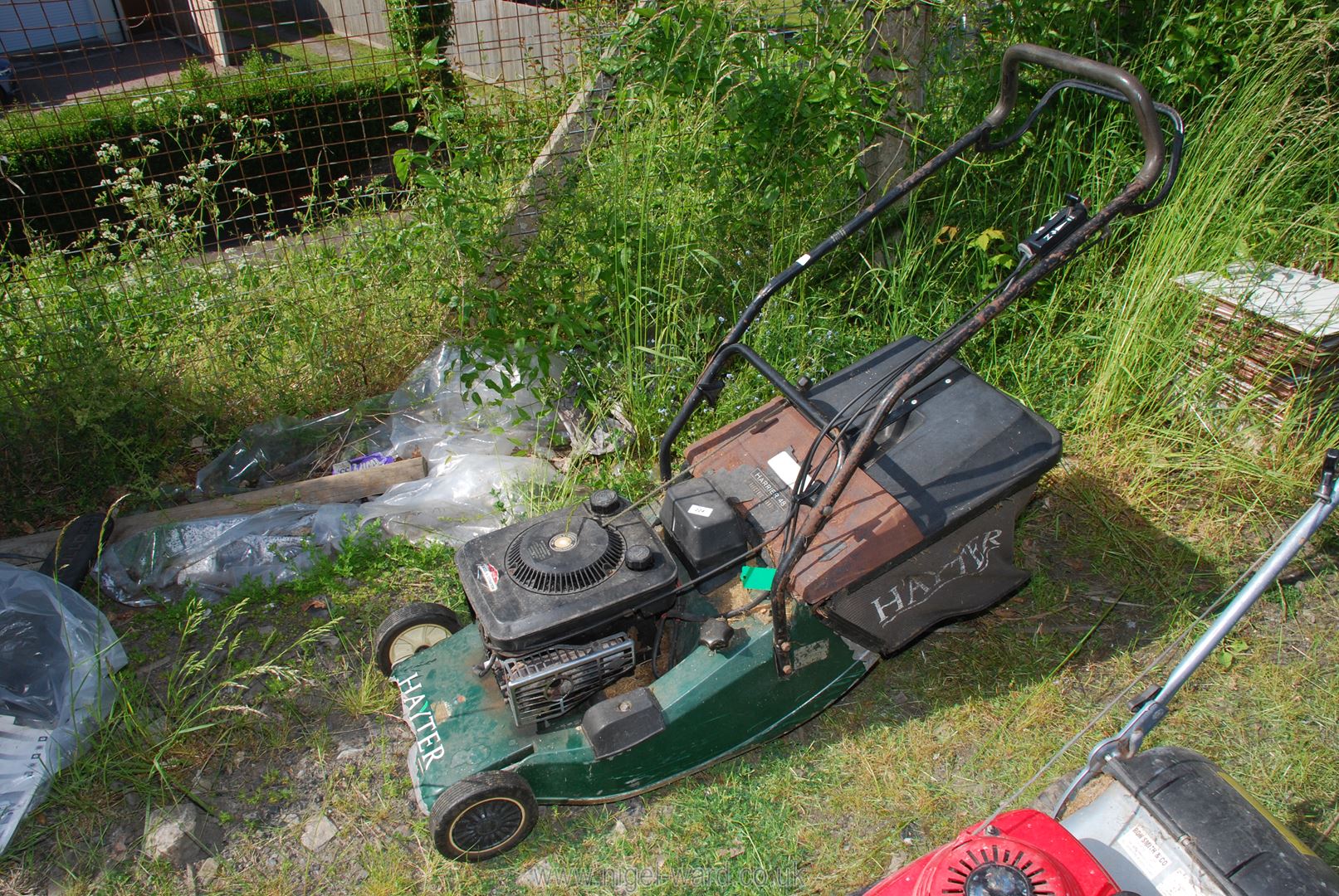 A Hayter Harrier 48 mower with grass box (starts with pull cord - in running order).