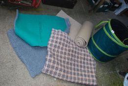 A pop up canvas bag, carpet sweeper, two pieces of pet bed and another pet bed.