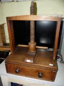 A 19th century Elm book press with drawer to base, thread screw pillar having acorn finial,