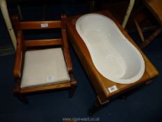 A child's commode chair and baby bath.