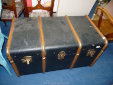 A bentwood bound travel trunk with contents.
