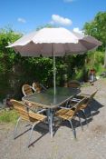A glass patio table, six chairs and umbrella (no drive bar).