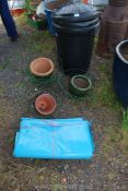 A plastic dustbin, glazed pots, plastic sheet, hanging baskets, etc.