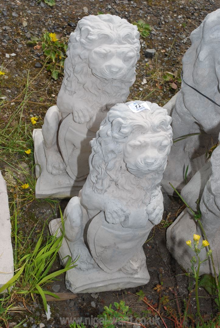 Two concrete heraldic lions with shields.