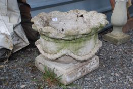 A shaped concrete planter with rope decoration, (separate base), 15" high x 19" diameter.