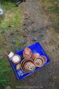 A quantity of terracotta pots and pot trolleys.