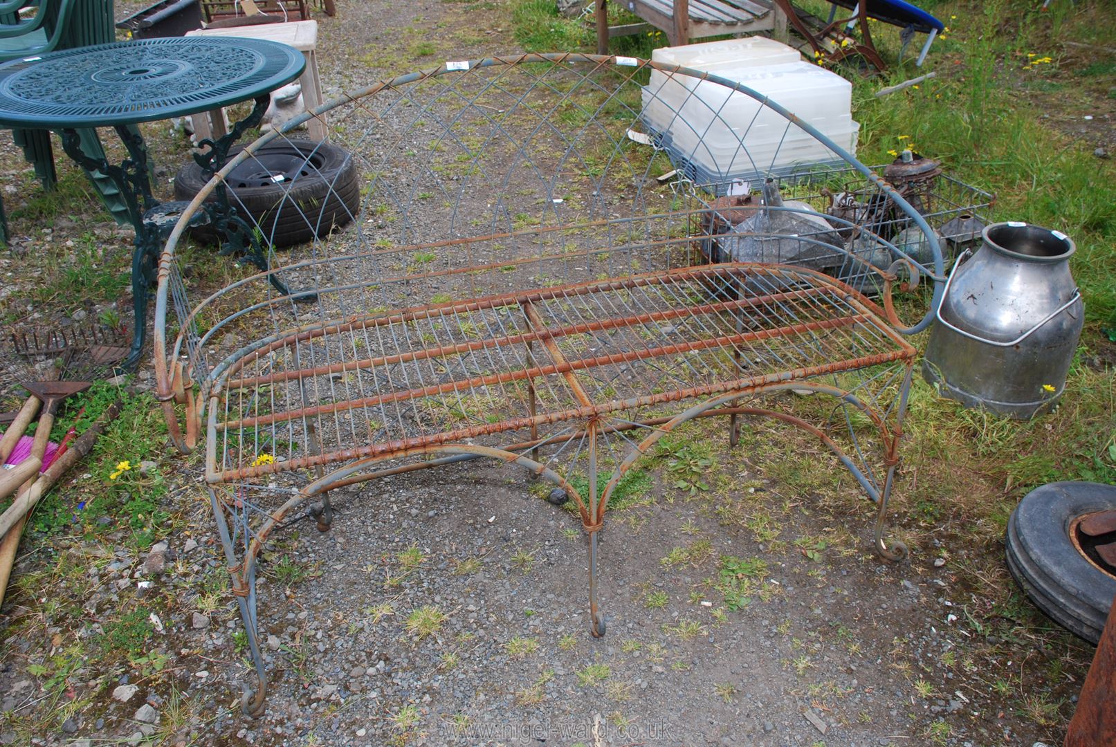 A French style metal bench, 4' wide x 34" high x 17" deep.