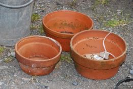 Three terracotta pots.