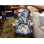 A circa 1900 Mahogany framed button backed Armchair having scroll detailed arms and front legs and