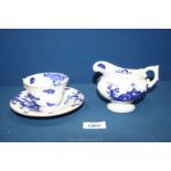 A Royal Worcester cup and saucer with matching jug in blue and white with dragon decoration and