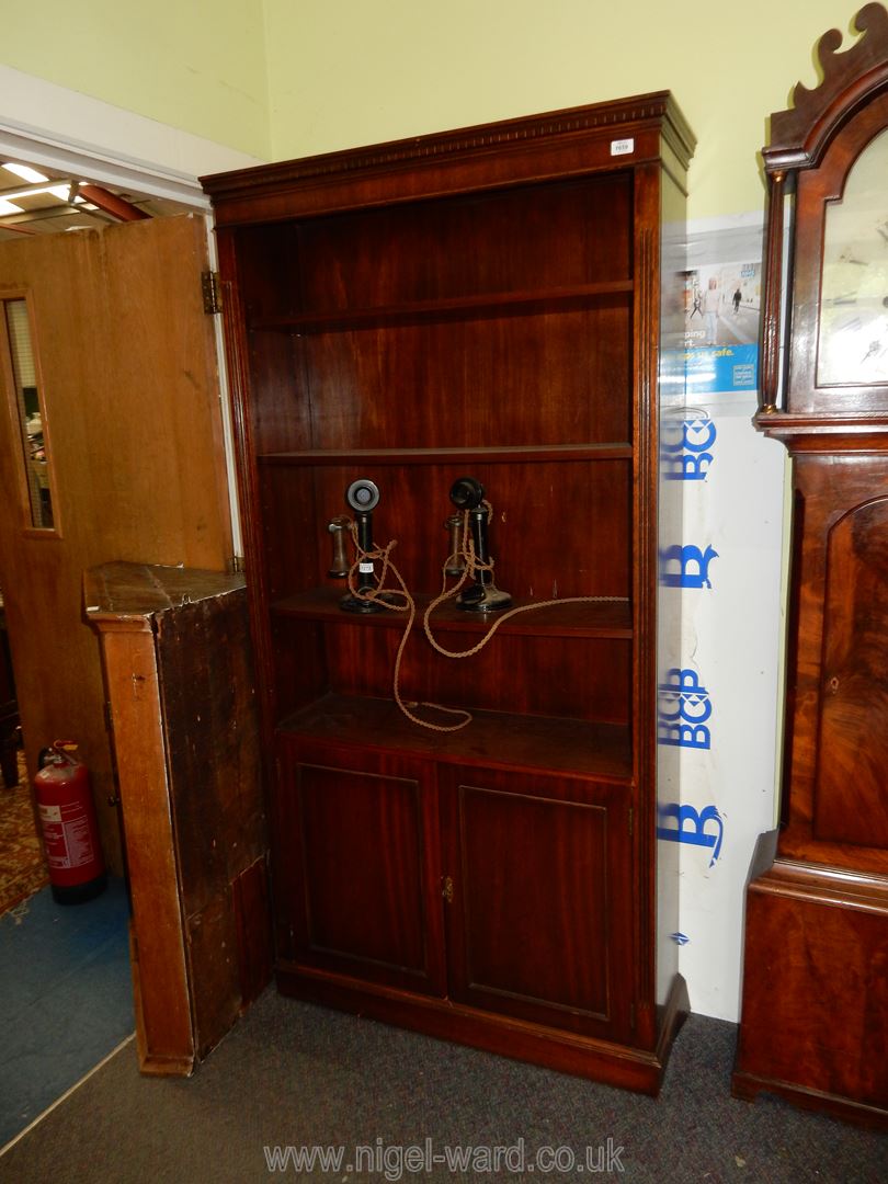 A set of Bookshelves with two door cupboard below.