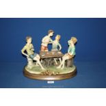 A large Naples porcelain figure of Card Players at Table, 12'' tall x 14 1/2'' wide overall.