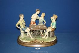 A large Naples porcelain figure of Card Players at Table, 12'' tall x 14 1/2'' wide overall.