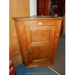 A medium Oak wall hanging Corner Cupboard, 32'' wide x 42 3/4'' high.