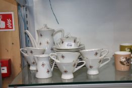 An Art Deco six setting Teaset in white with orange and gold pattern.