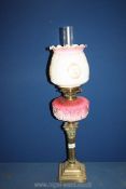 A double burner Oil Lamp on Corinthian column with pink and white china reservoir and milk glass