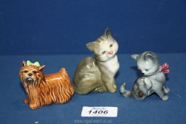 A small grey and white Beswick cat, West German kitten and Goebel Yorkshire Terrier with green bow.