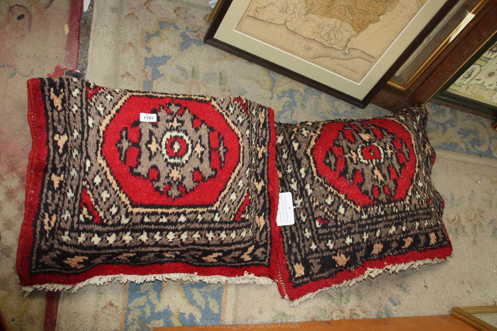 A pair of Uzbeck hand knotted cushions in red and grey, 25'' x 19''.