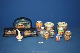 A box of oriental items to include cork pictures and china vases etc.